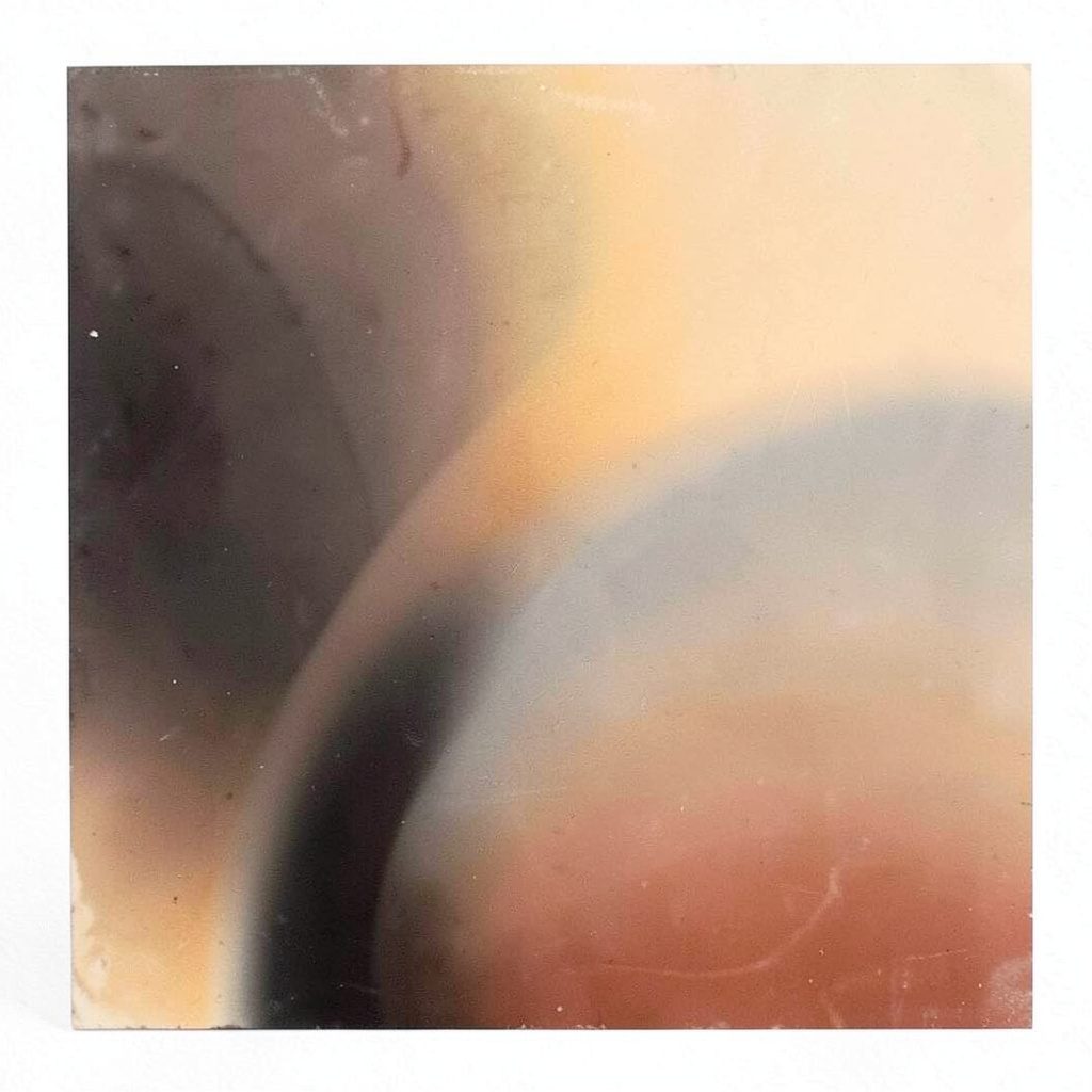 Abstract gradient composition in charcoal and warm stone, square format with no figures or objects.